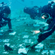 Divers with a recent film crew over wreckage identified as part of Challenger.